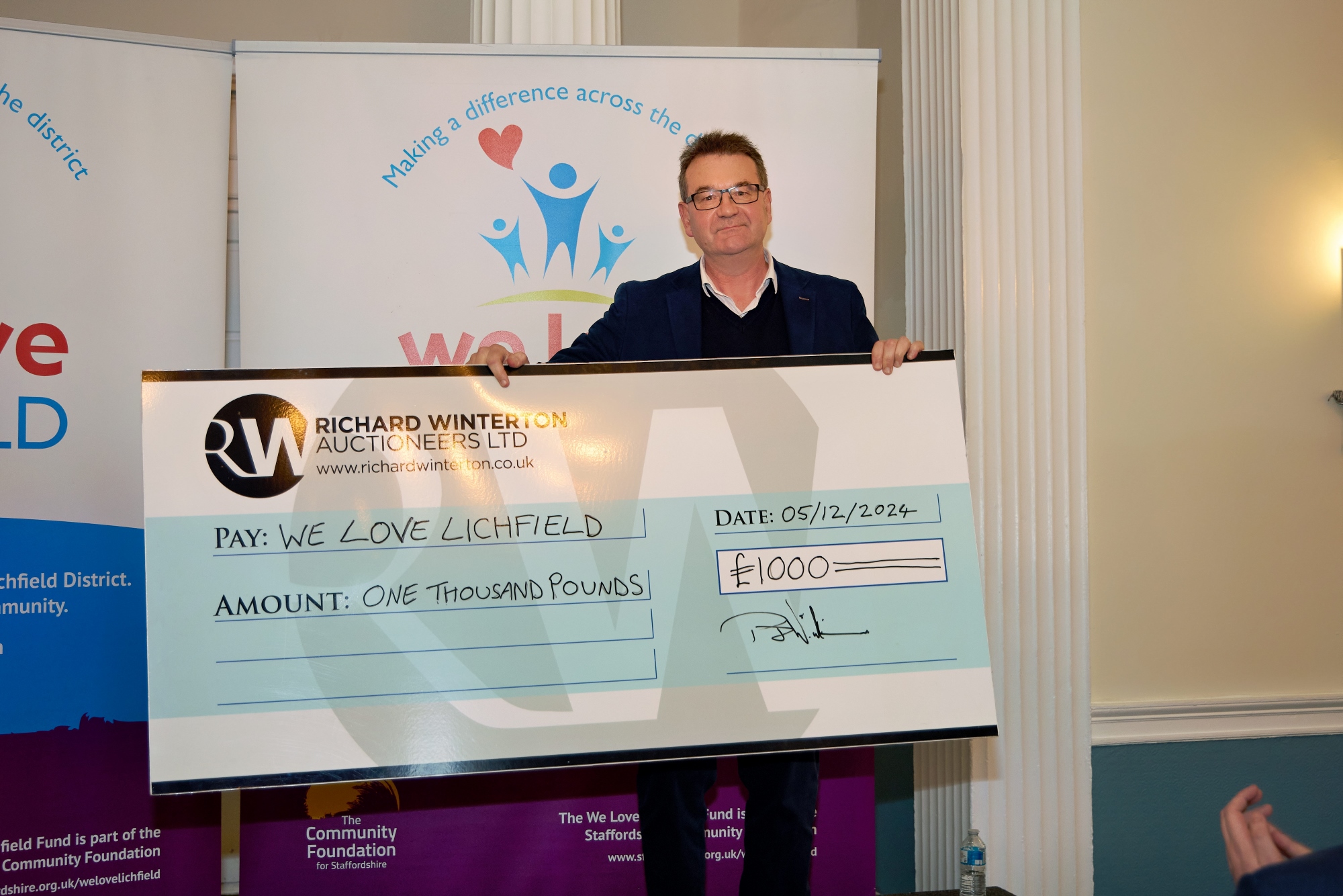 Richard Winterton presented We Love Lichfield with £1,000 at the Christmas Giveaway.