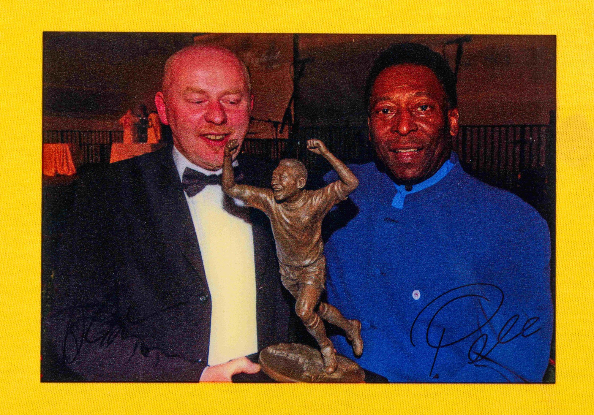 The photo of Pelé with sculptor Andy Edwards and the bronze figurine, signed by them both.