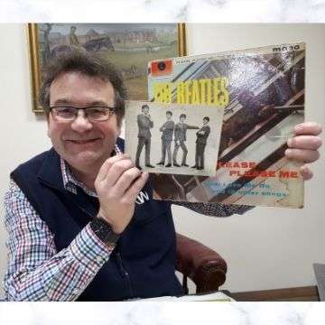 A Beatles photograph signed by John, Paul, George and Ringo during a break in filming at a Birmingham television studio. The photo will go under the hammer as Lot 372 in Richard Winterton Auctioneers’ Antiques & Home Sale on Monday, April 12. Pictured is auctioneer Richard Winterton with the rare autographed photo and a copy of The Beatles’ first LP Please Please Me.