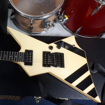 A 1985 Gibson Custom Shop XPL Explorer guitar with a cream finish, black detailing, Kahler floating tremolo and two Seymour Duncan humbucking pickups.