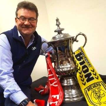 Auctioneer Richard Winterton with a Portmeirion ceramic replica of the FA Cup.