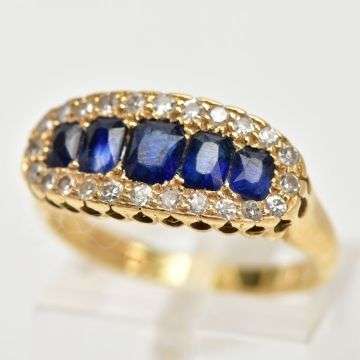 Lot 34: An 18ct gold sapphire and diamond half hoop ring.