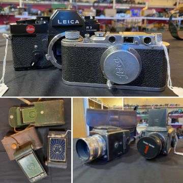 A Leica R3 SLR camera and a Leica 2 Rangefinder; two medium format cameras; two Kodak boy scout and one girl guide folding cameras.