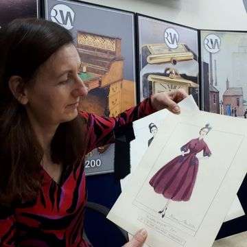 Senior valuer Sarah Williams inspects the Norman Hartnell dress designs for Princess Margaret.