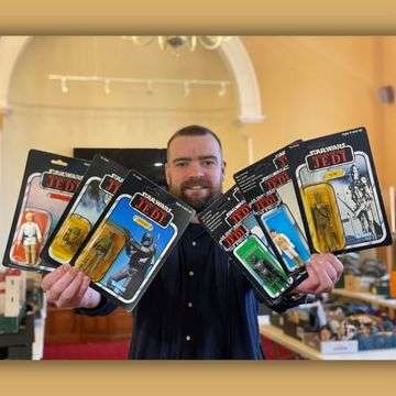 Auctioneer Ben Winterton with some of the original Kenner and Palitoy Star Wars figures in sealed blister packs.