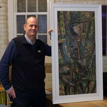 Valuation and saleroom assistant Paul Williams with the William Black cubist painting ‘Girl With A Hat’.