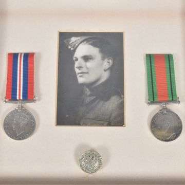 Leslie Lee's framed medals are accompanied by the King’s badge for loyal service.