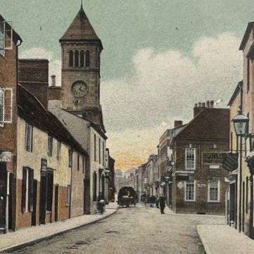 A detail of a postcard showing Lichfield's clock tower in its original position at the junction of Bird Street and Bore Street. Build in 1863, the clock tower was moved 400m west in 1928 to accommodate the building of The Friary road.