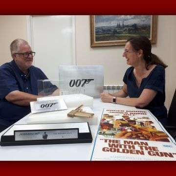 Tony Swift with senior valuer Sarah Williams discussing the golden gun at The Lichfield Auction Centre.