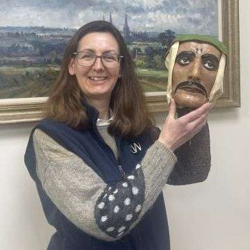 Senior valuer for Richard Winterton Auctioneers Sarah Williams with the Joe Keppel mask.