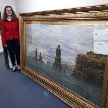 Senior valuer Sarah Williams with MacLeod’s Maidens, Skye, by John Brett.